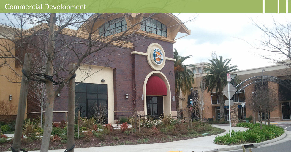 Melton Design Group, a landscape architecture firm, designed Dave and Busters in Roseville, CA. Dark classic brick building with cream colored concrete trim and almond mulch landscaping complete with desert plants.