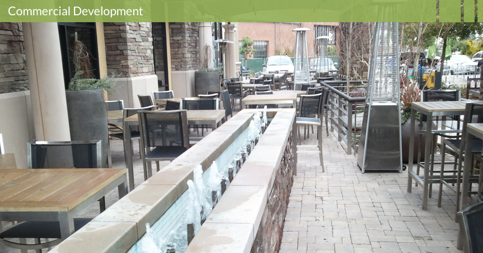 Melton Design Group, a landscape architecture firm, designed this fountain at Dave and Buster’s in Roseville, CA. This trough like fountain is the centerpiece of the outside patio complete with brick and cobblestone textured walls and flooring.